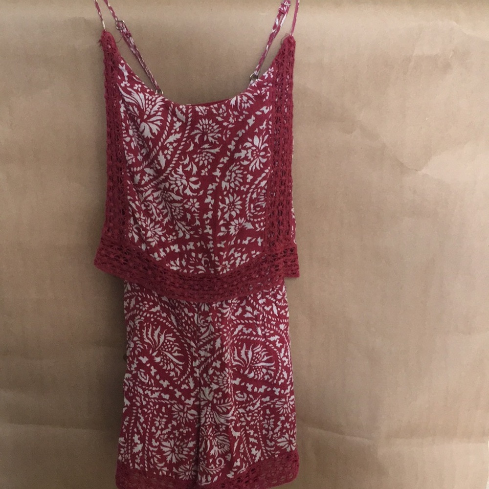 This item is a red patterned romper